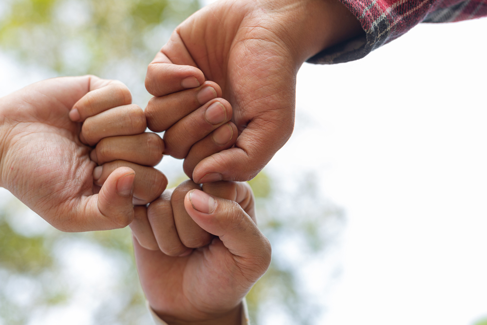Hands fist-bumping